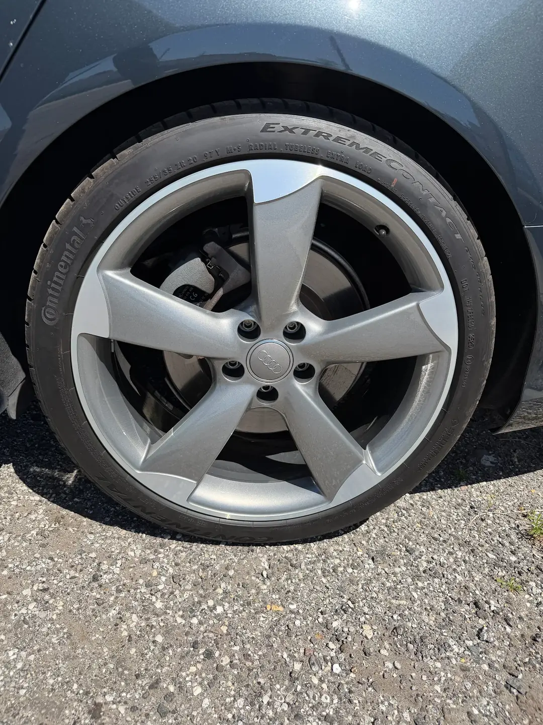 Refinished gunmetal Audi wheel mounted on car