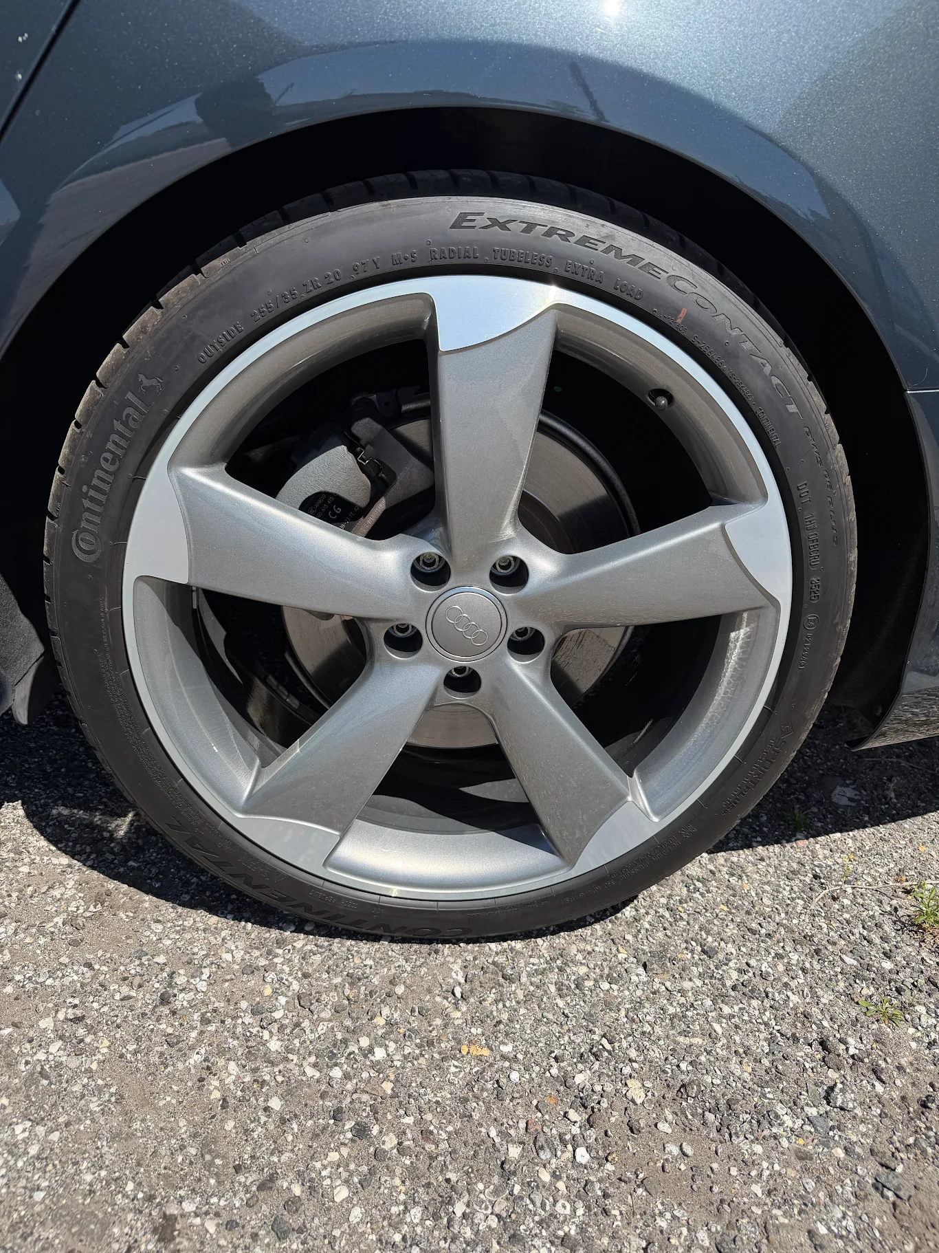 Refinished gunmetal Audi wheel mounted on car